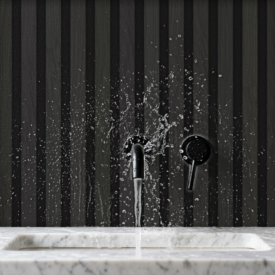 Black Dry-Slat waterproof slat wall panels with water splashing on them behind a basin tap – waterproof